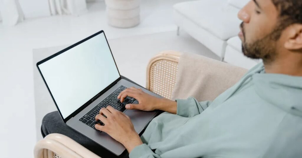 Person typing on laptop keyboard, showing how to screenshot on Acer laptop