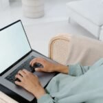 Person typing on laptop keyboard, showing how to screenshot on Acer laptop