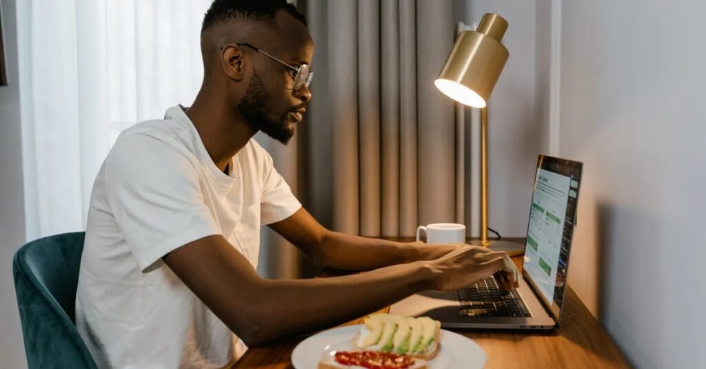 how to screenshot on asus laptop, person using a laptop at a desk.