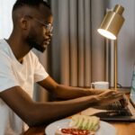how to screenshot on asus laptop, person using a laptop at a desk.