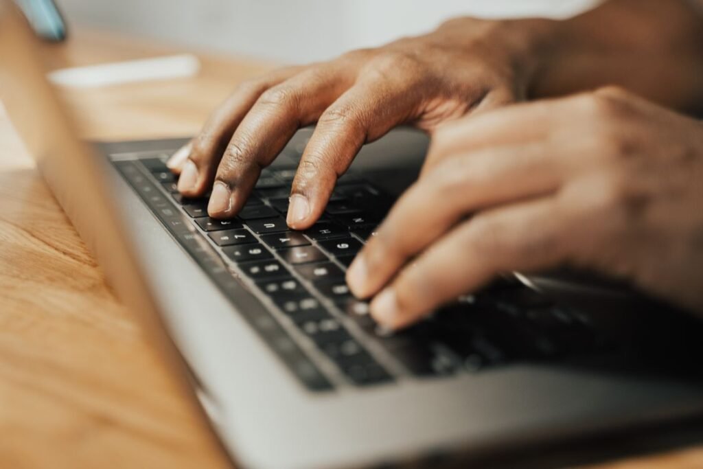 Person typing on a Lenovo laptop keyboard showing how to screenshot on Lenovo laptop